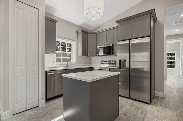 kitchen with a healthy amount of sunlight, wood tiled floor, visible vents, and stainless steel appliances