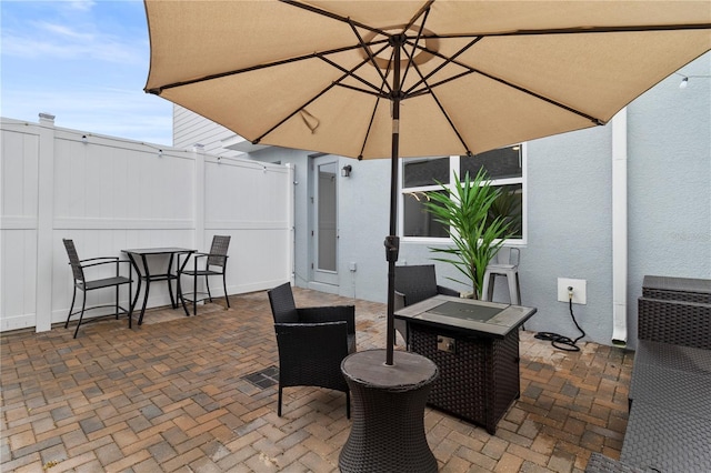 view of patio / terrace featuring outdoor dining area and fence