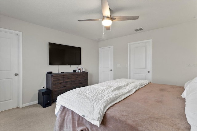 bedroom featuring light carpet, ceiling fan, and visible vents