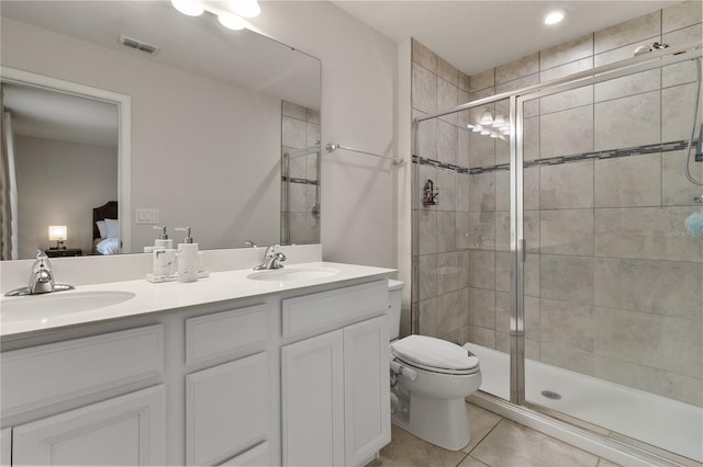 bathroom with toilet, ensuite bath, visible vents, and a sink