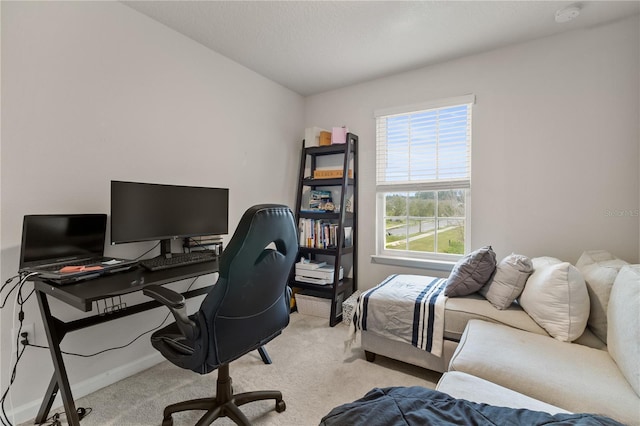 office space with light carpet and baseboards