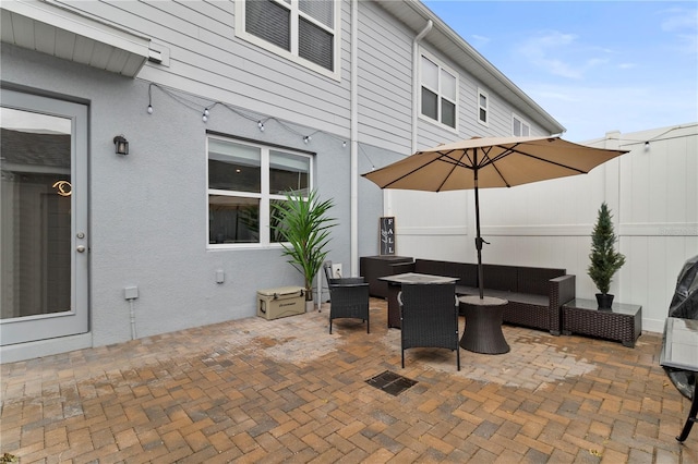 view of patio / terrace featuring fence and outdoor lounge area