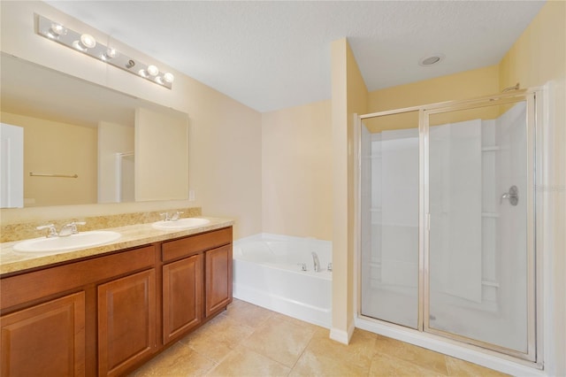 bathroom with a stall shower and a sink