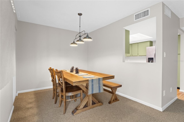 dining area with visible vents, baseboards, and carpet flooring