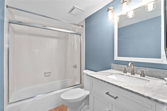 bathroom with vanity, shower / bathtub combination with curtain, visible vents, a textured ceiling, and toilet