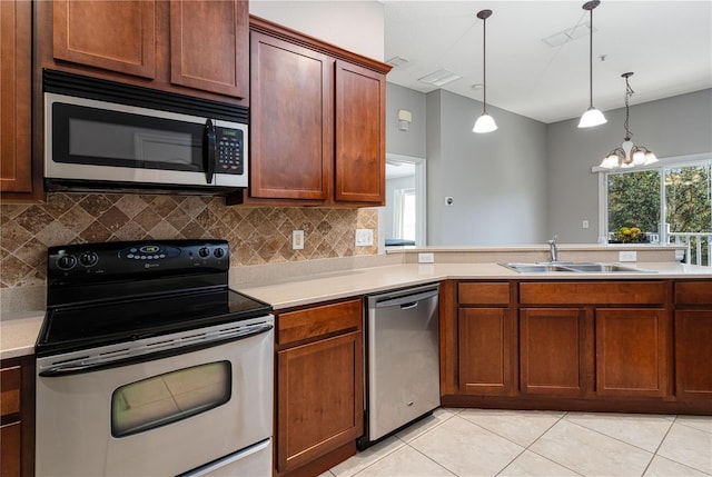 kitchen with light countertops, appliances with stainless steel finishes, and a sink