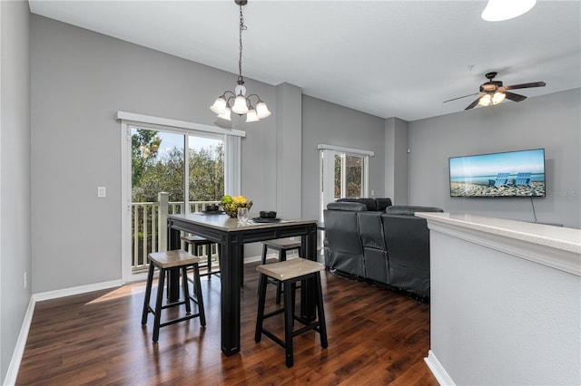 dining room with baseboards, dark wood finished floors, and a healthy amount of sunlight