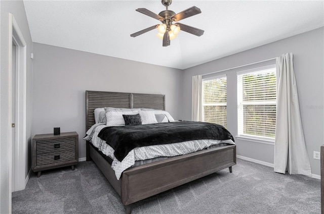 carpeted bedroom with ceiling fan, baseboards, and vaulted ceiling