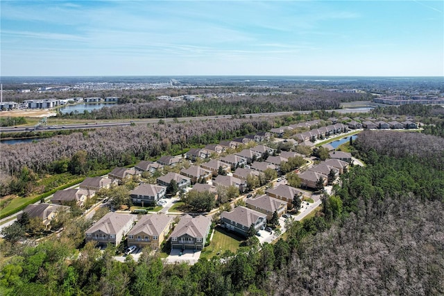 birds eye view of property with a water view and a residential view