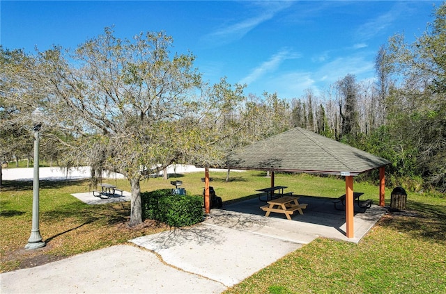 view of property's community with a yard and a gazebo