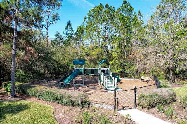 communal playground featuring fence and a gate