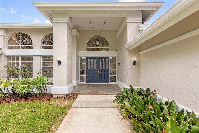 doorway to property featuring french doors and stucco siding