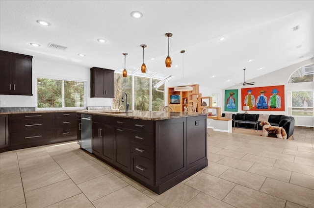 kitchen featuring light tile patterned floors, stone counters, visible vents, and a sink