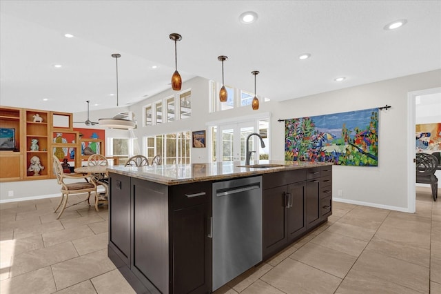 kitchen featuring a center island with sink, pendant lighting, dishwasher, and a sink