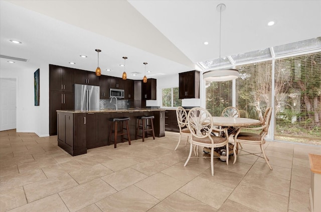 dining room featuring lofted ceiling, light tile patterned flooring, and recessed lighting