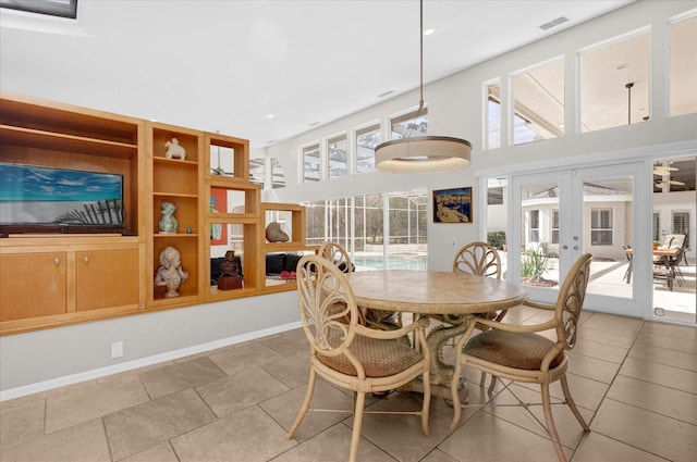 dining room with baseboards, french doors, visible vents, and a healthy amount of sunlight