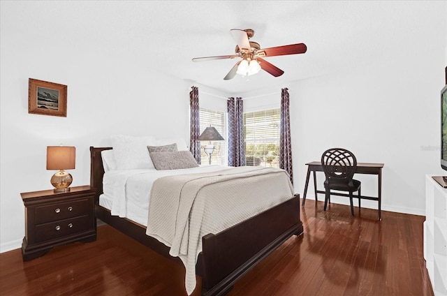 bedroom with a ceiling fan, baseboards, and wood finished floors