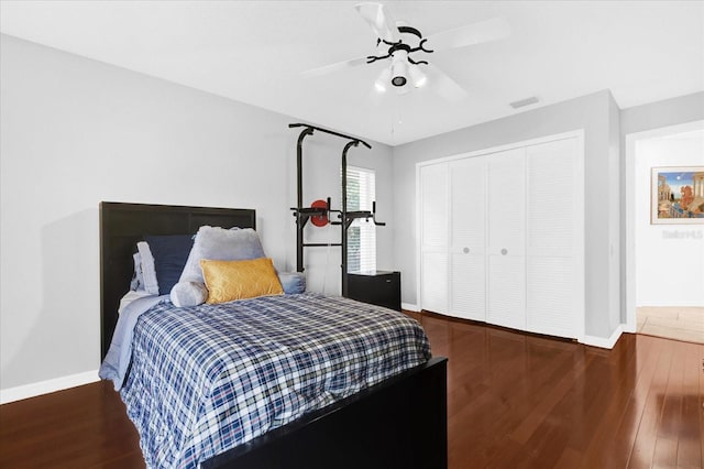 bedroom featuring visible vents, baseboards, and wood finished floors