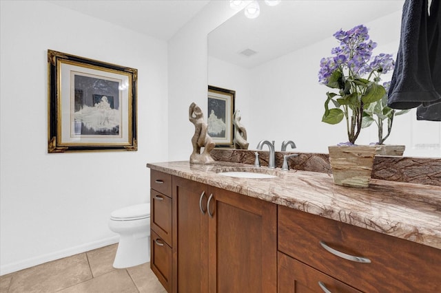 bathroom featuring baseboards, visible vents, toilet, tile patterned floors, and vanity