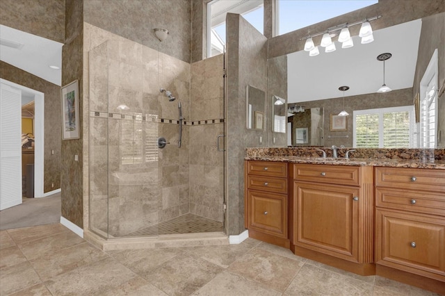 bathroom with a shower stall, visible vents, and vanity