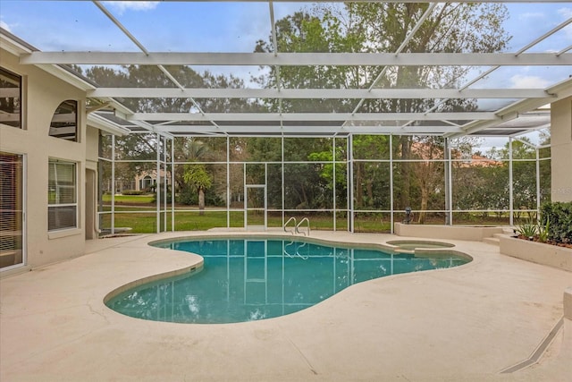 view of swimming pool featuring a patio, a lanai, and a pool with connected hot tub