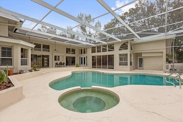 view of swimming pool with a patio, a pool with connected hot tub, a lanai, and a ceiling fan