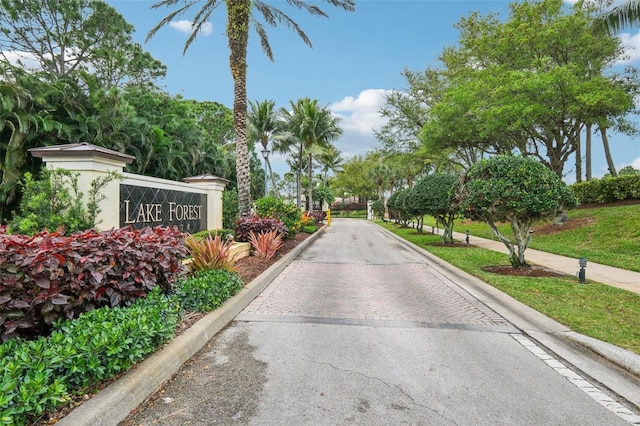 view of street featuring curbs and a gated entry