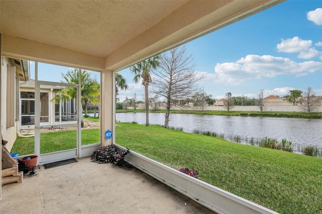 unfurnished sunroom featuring a water view