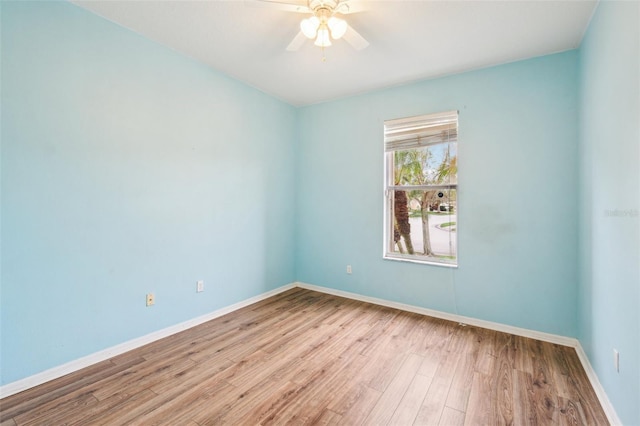 unfurnished room with ceiling fan, baseboards, and wood finished floors