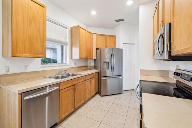 kitchen with visible vents, a sink, stainless steel appliances, light countertops, and light tile patterned floors