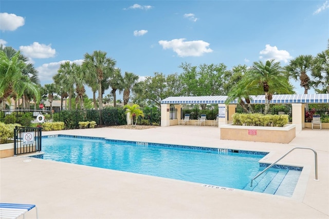 community pool featuring a patio area and fence