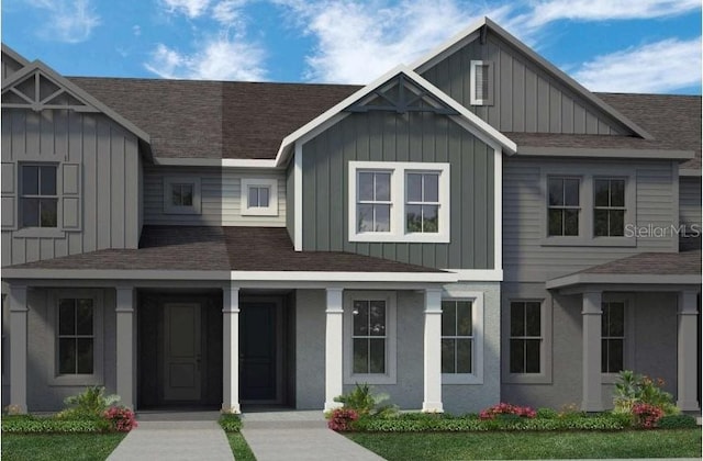 view of front of home featuring board and batten siding, covered porch, and a shingled roof