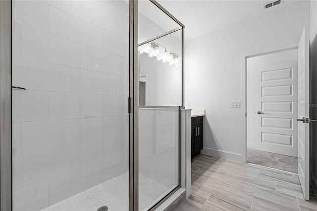 full bath featuring baseboards, visible vents, vanity, and a shower stall