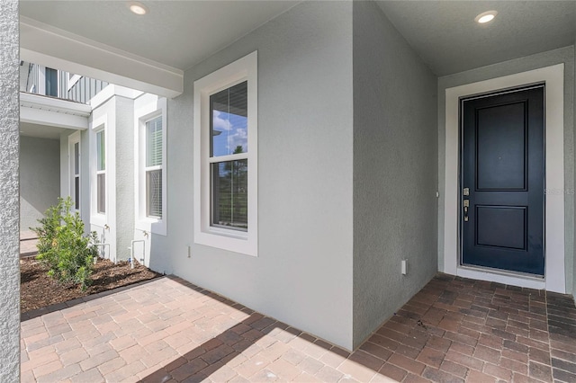 doorway to property with stucco siding