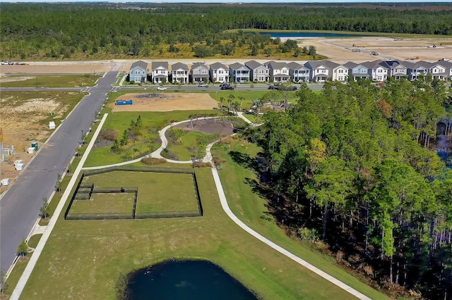 drone / aerial view with a residential view and a wooded view