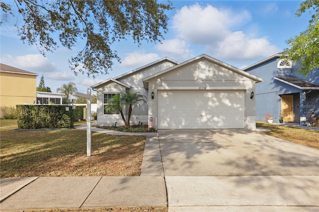 ranch-style house featuring concrete driveway, a garage, a front yard, and stucco siding