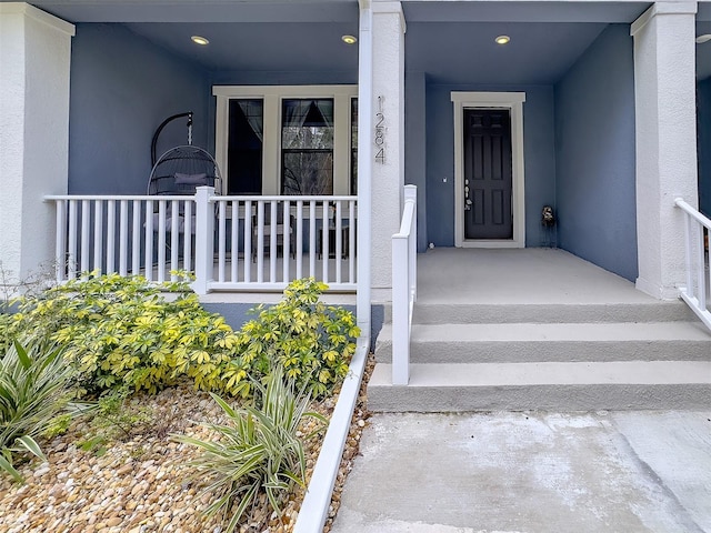 view of exterior entry with stucco siding