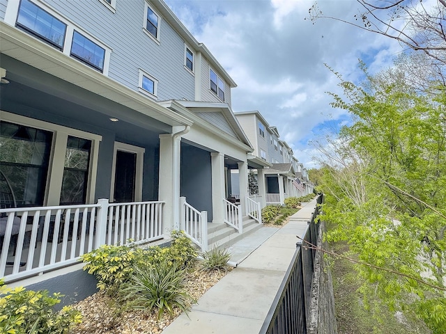 view of side of property with a porch