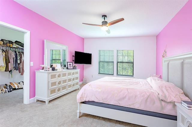 carpeted bedroom featuring ceiling fan, a closet, and baseboards