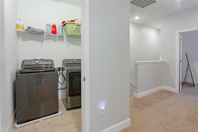 laundry area featuring laundry area, baseboards, visible vents, and separate washer and dryer