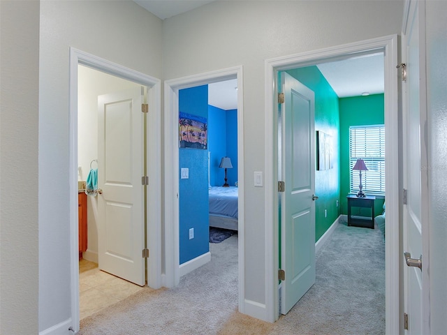 hall featuring carpet floors and baseboards