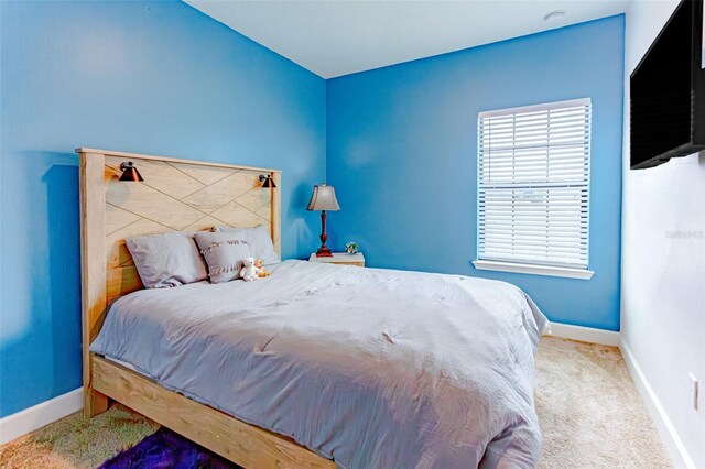 carpeted bedroom featuring baseboards