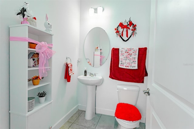 bathroom featuring tile patterned flooring, toilet, and baseboards