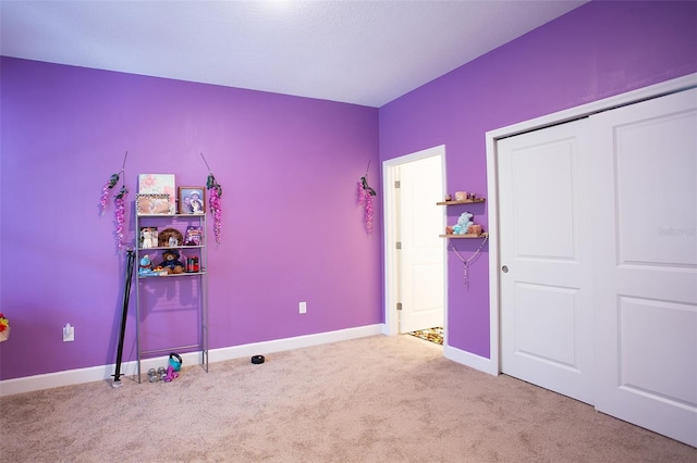 interior space with carpet floors, baseboards, and a closet