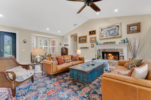 living area with visible vents, a brick fireplace, baseboards, vaulted ceiling, and recessed lighting