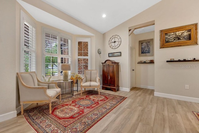 sitting room with recessed lighting, wood finished floors, baseboards, and vaulted ceiling