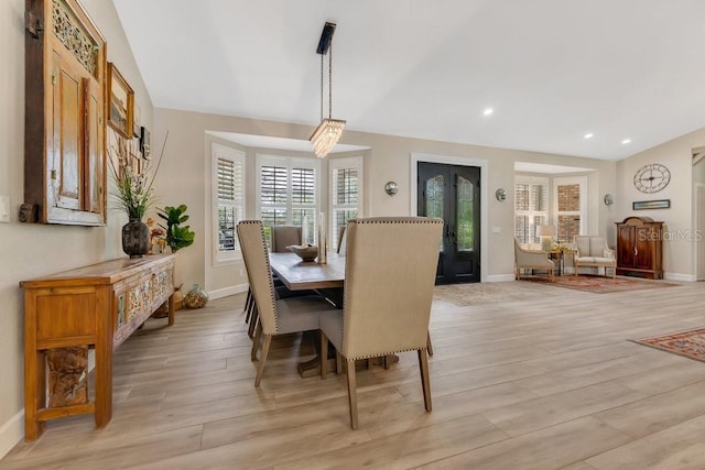 dining area featuring recessed lighting, baseboards, lofted ceiling, and light wood finished floors