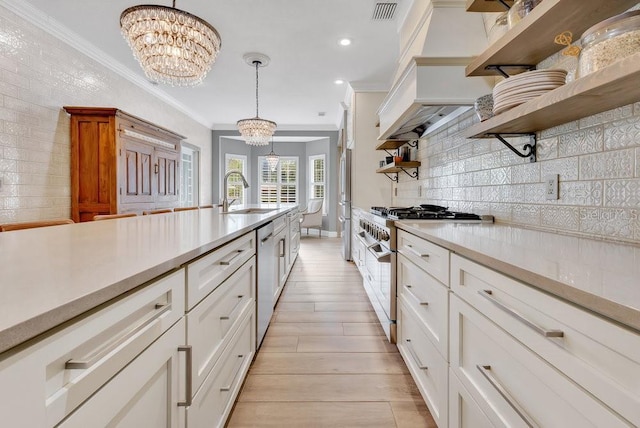 kitchen with visible vents, a sink, open shelves, appliances with stainless steel finishes, and an inviting chandelier