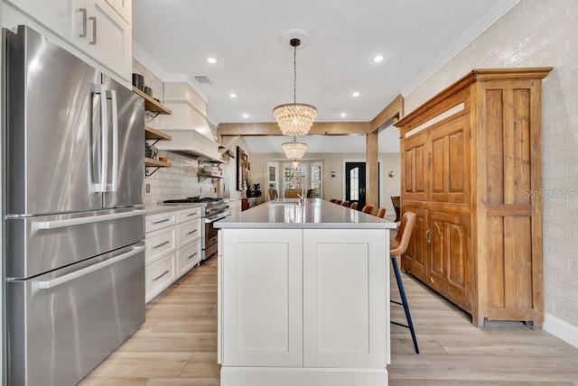 kitchen with open shelves, a barn door, light countertops, and stainless steel appliances