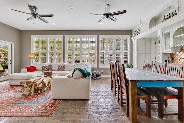 living room featuring recessed lighting, brick floor, and ceiling fan